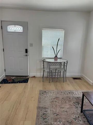 a view of a workspace with furniture and wooden floor