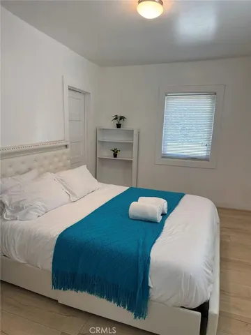 a bedroom with a bed and a couch