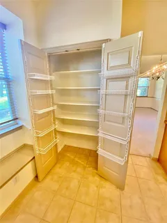 a view of a room with shelves on the wall