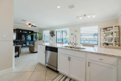 a kitchen with a sink and white cabinets