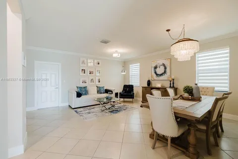 a living room with furniture a clock and white walls