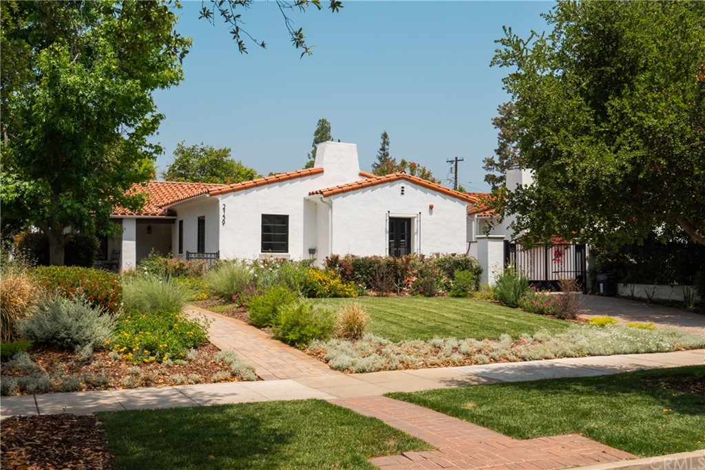 2159 Lorain Road San Marino, CA 91108 - Photo 2 of 42 a view of a white house next to a yard with plants and large trees