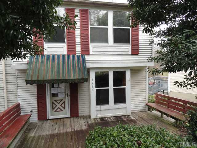 1130 Villa Green Court Raleigh, NC 27612 - Photo 2 of 9 a front view of a house with a garage