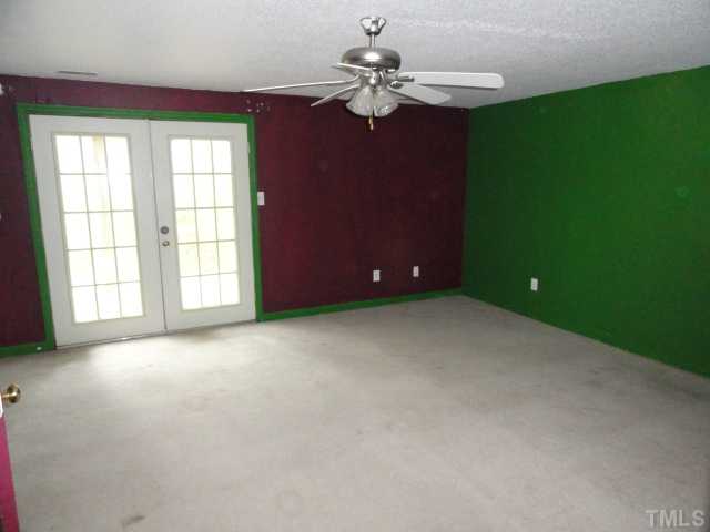 1130 Villa Green Court Raleigh, NC 27612 - Photo 5 of 9 an empty room with windows and fan