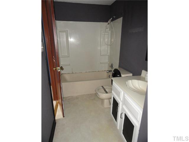 1130 Villa Green Court Raleigh, NC 27612 - Photo 7 of 9 a bathroom with a sink a toilet and shower