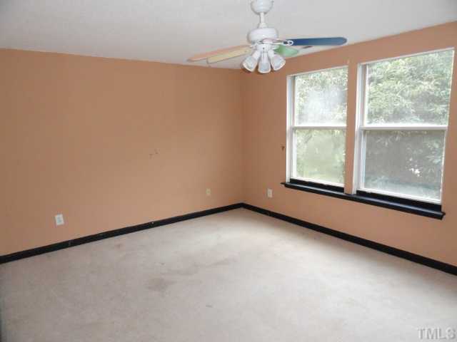 1130 Villa Green Court Raleigh, NC 27612 - Photo 8 of 9 wooden floor in an empty room with a window