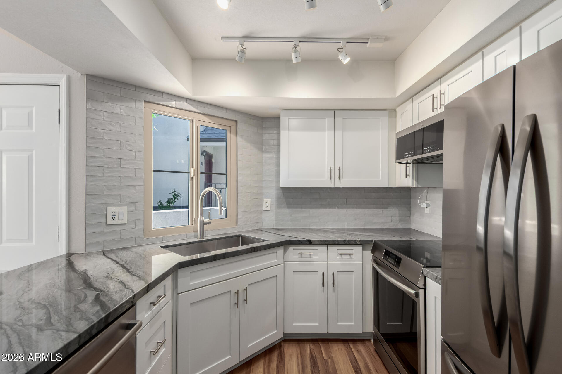 100 East Fillmore Street, Unit 119 Phoenix, AZ 85004 - Photo 11 of 34 a kitchen with stainless steel appliances granite countertop a sink stove and refrigerator
