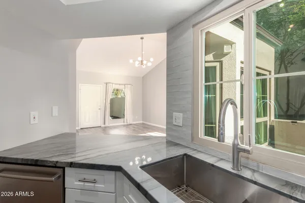 a kitchen with stainless steel appliances granite countertop a refrigerator sink and stove