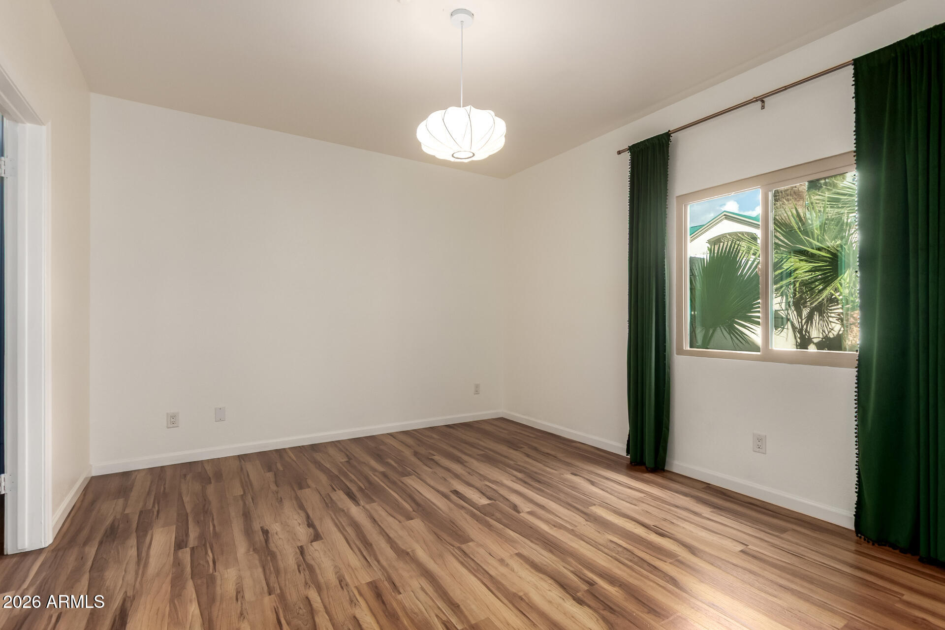 100 East Fillmore Street, Unit 119 Phoenix, AZ 85004 - Photo 16 of 34 wooden floor in an empty room with a window