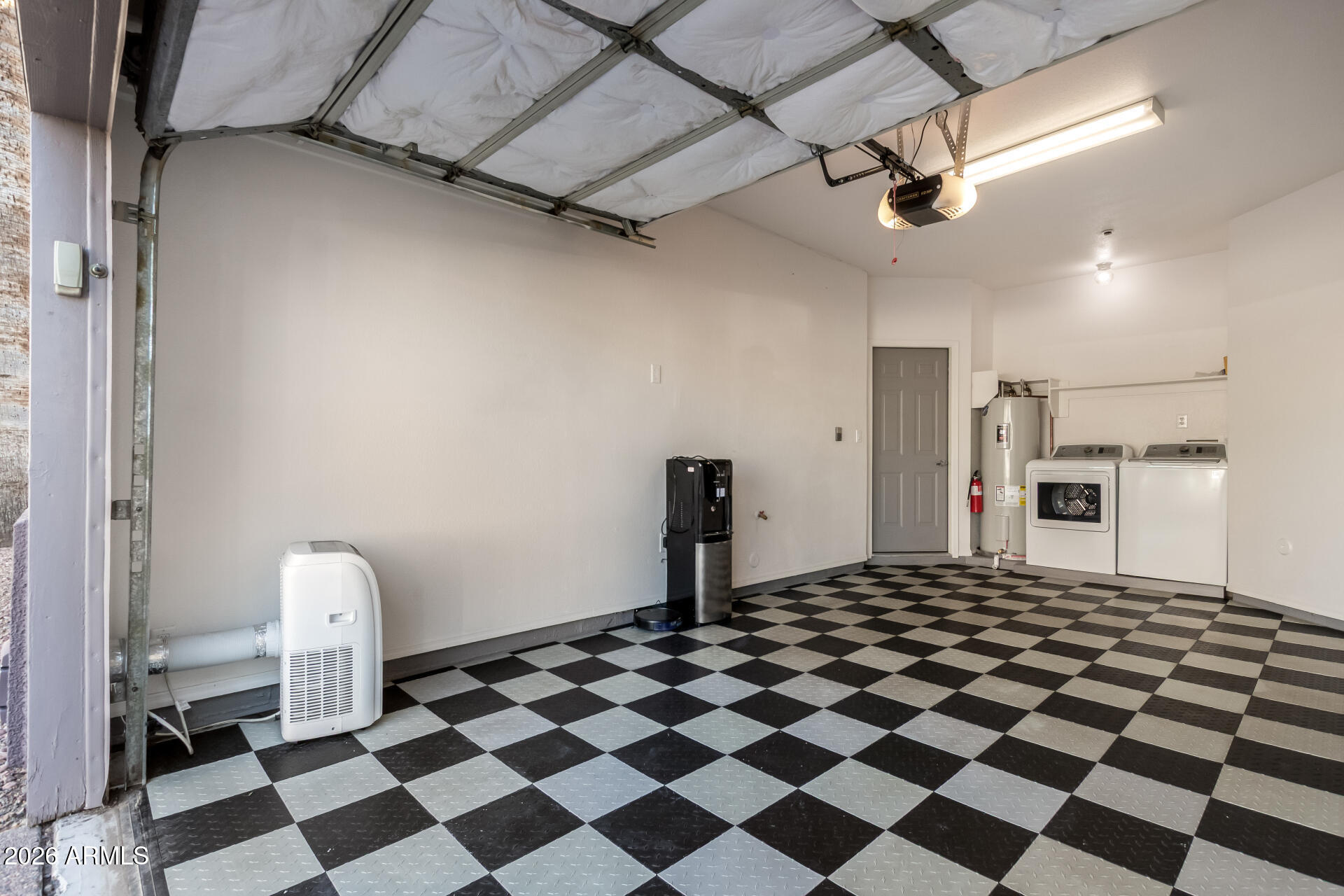 100 East Fillmore Street, Unit 119 Phoenix, AZ 85004 - Photo 22 of 34 a kitchen with a checkered floor and white cabinets