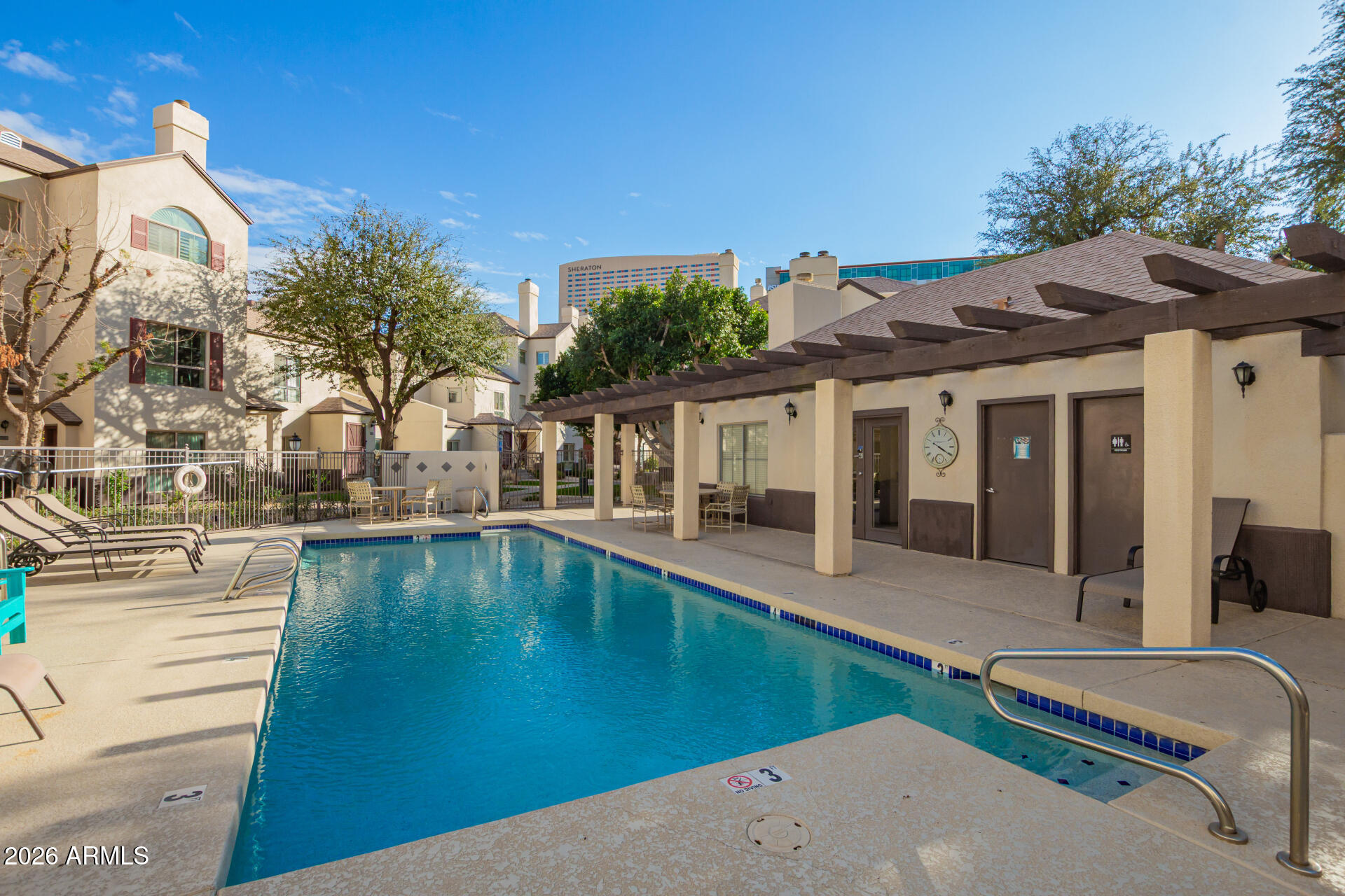 100 East Fillmore Street, Unit 119 Phoenix, AZ 85004 - Photo 27 of 34 a swimming pool with outdoor seating and yard