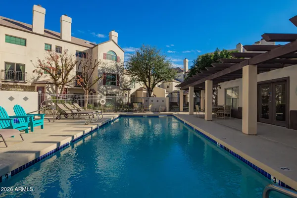 a swimming pool with outdoor seating and yard