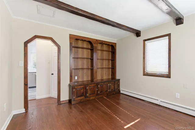 a view of a livingroom with wooden floor and furniture