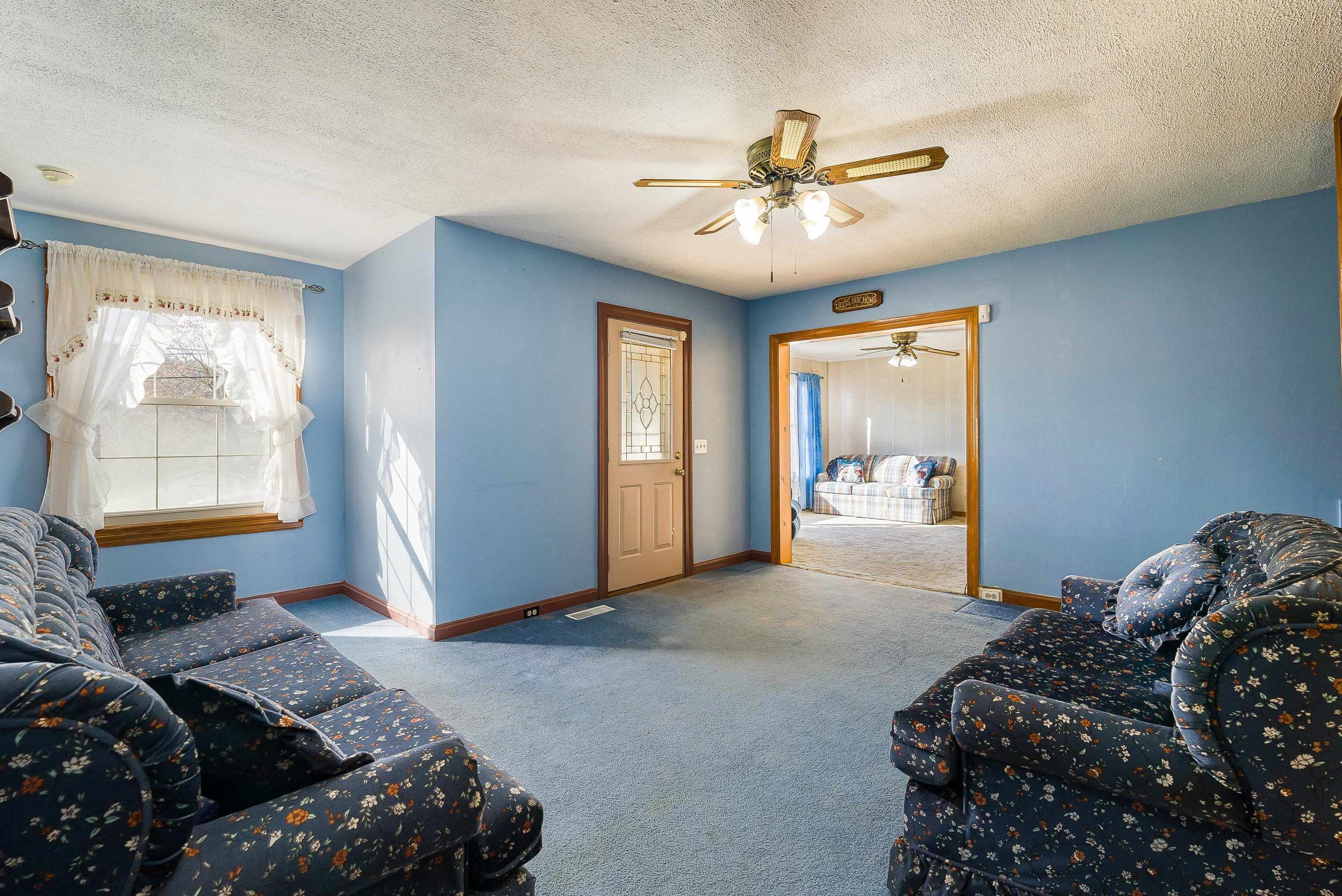 18753 Mt Pleasant Road Elkton, VA 22827 - Photo 11 of 34 a bedroom with a large bed and a chandelier