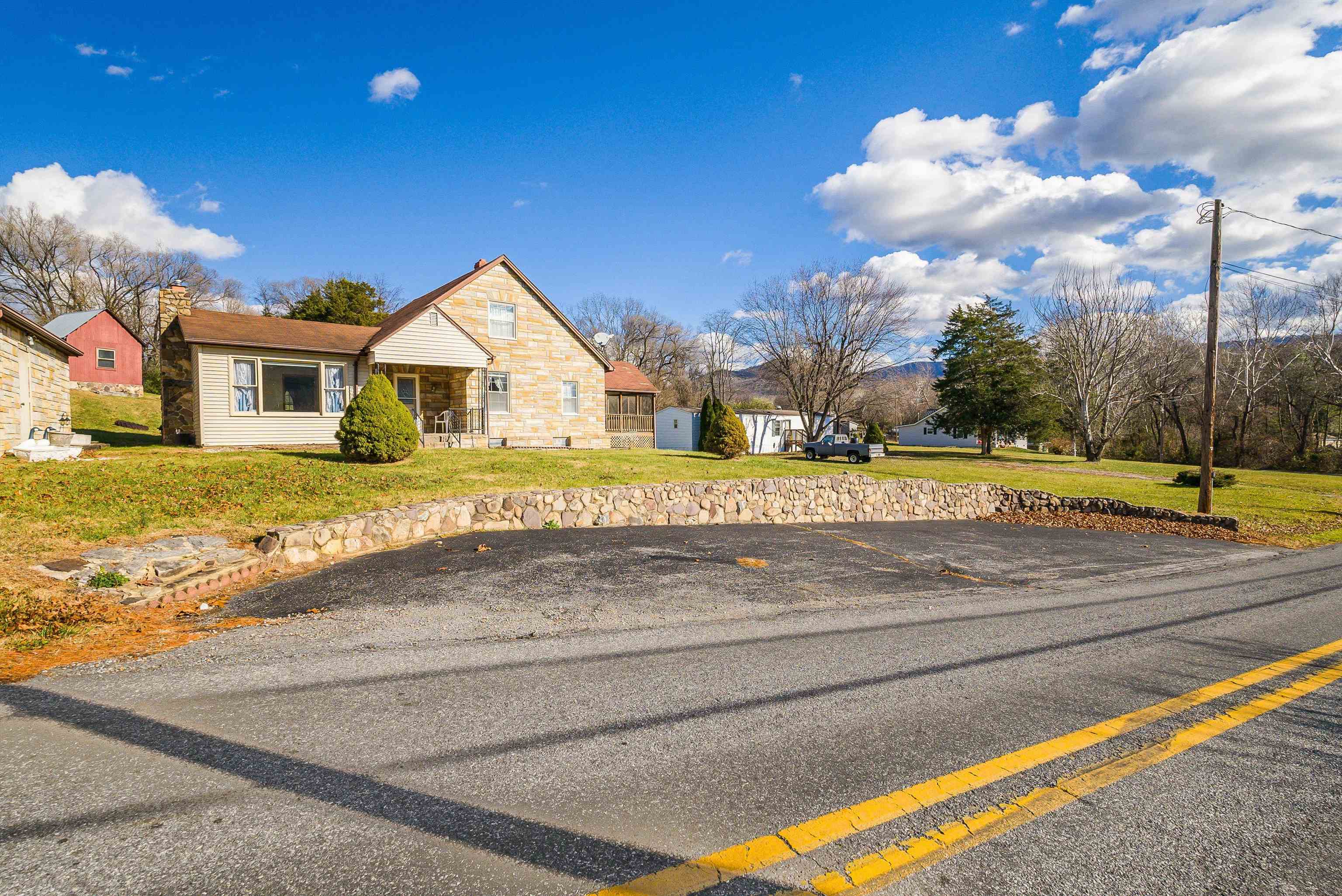 18753 Mt Pleasant Road Elkton, VA 22827 - Photo 5 of 34 a view of a house with a big yard and large trees