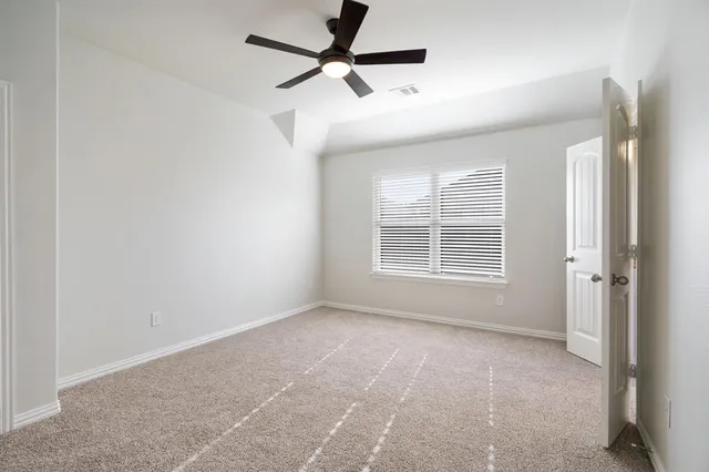 a view of a livingroom with a ceiling fan and window
