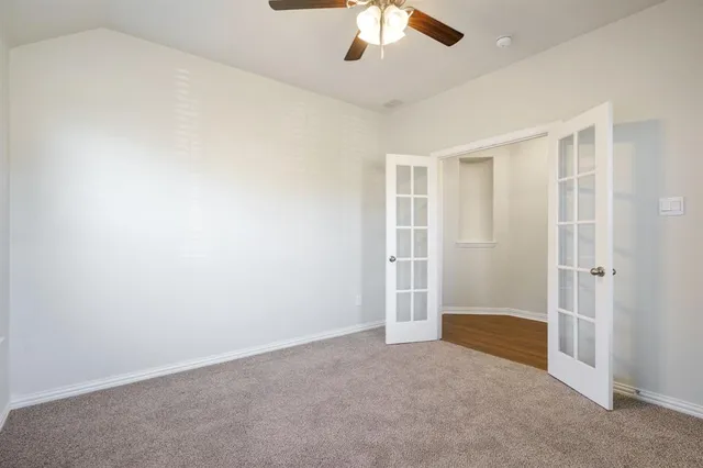 an empty room with a empty space and a ceiling fan