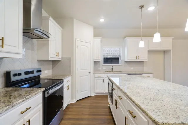 a kitchen with a sink dishwasher stove and refrigerator