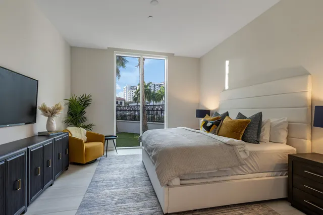 a bedroom with a balcony a bed and a couch