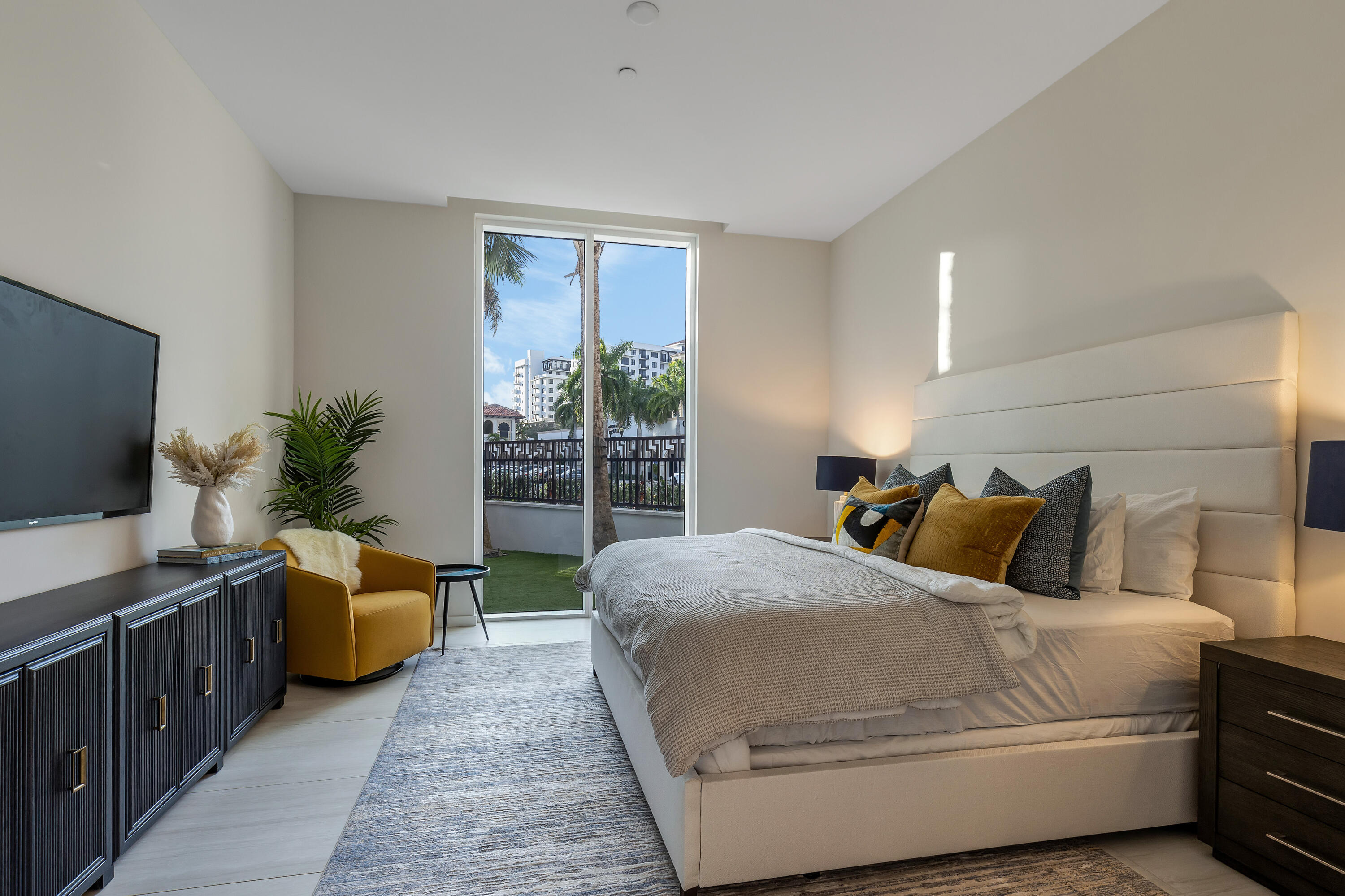 200 Southeast Mizner Boulevard, Unit 106 Boca Raton, FL 33432 - Photo 11 of 43 a bedroom with a balcony a bed and a couch