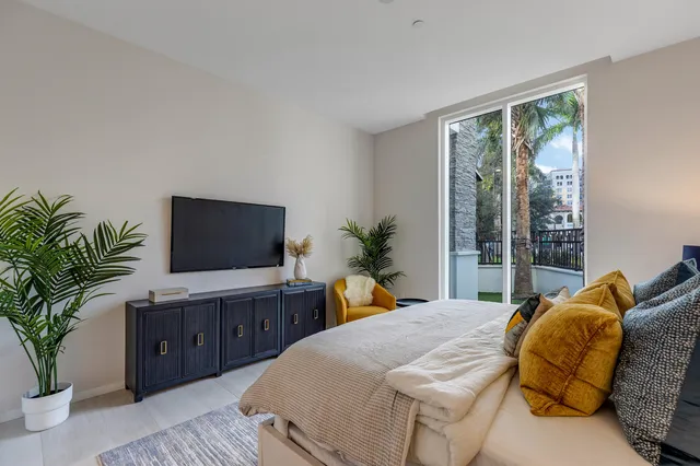 a bedroom with a large bed and a flat screen television