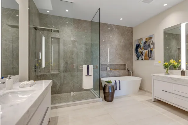 a spacious bathroom with a tub a sink and mirror