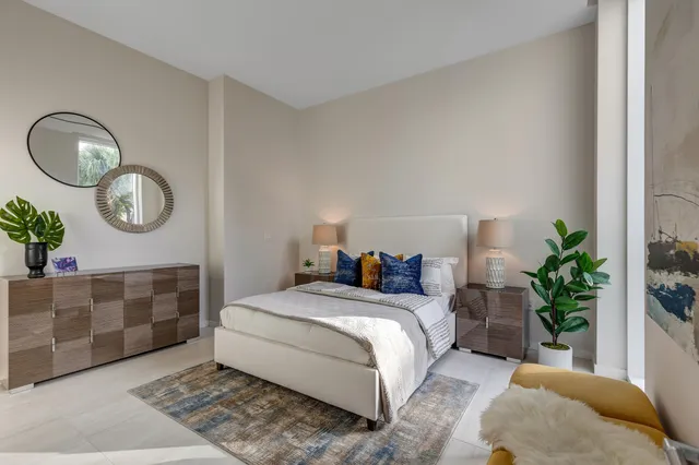 a bedroom with a bed flowerpot and a potted plant