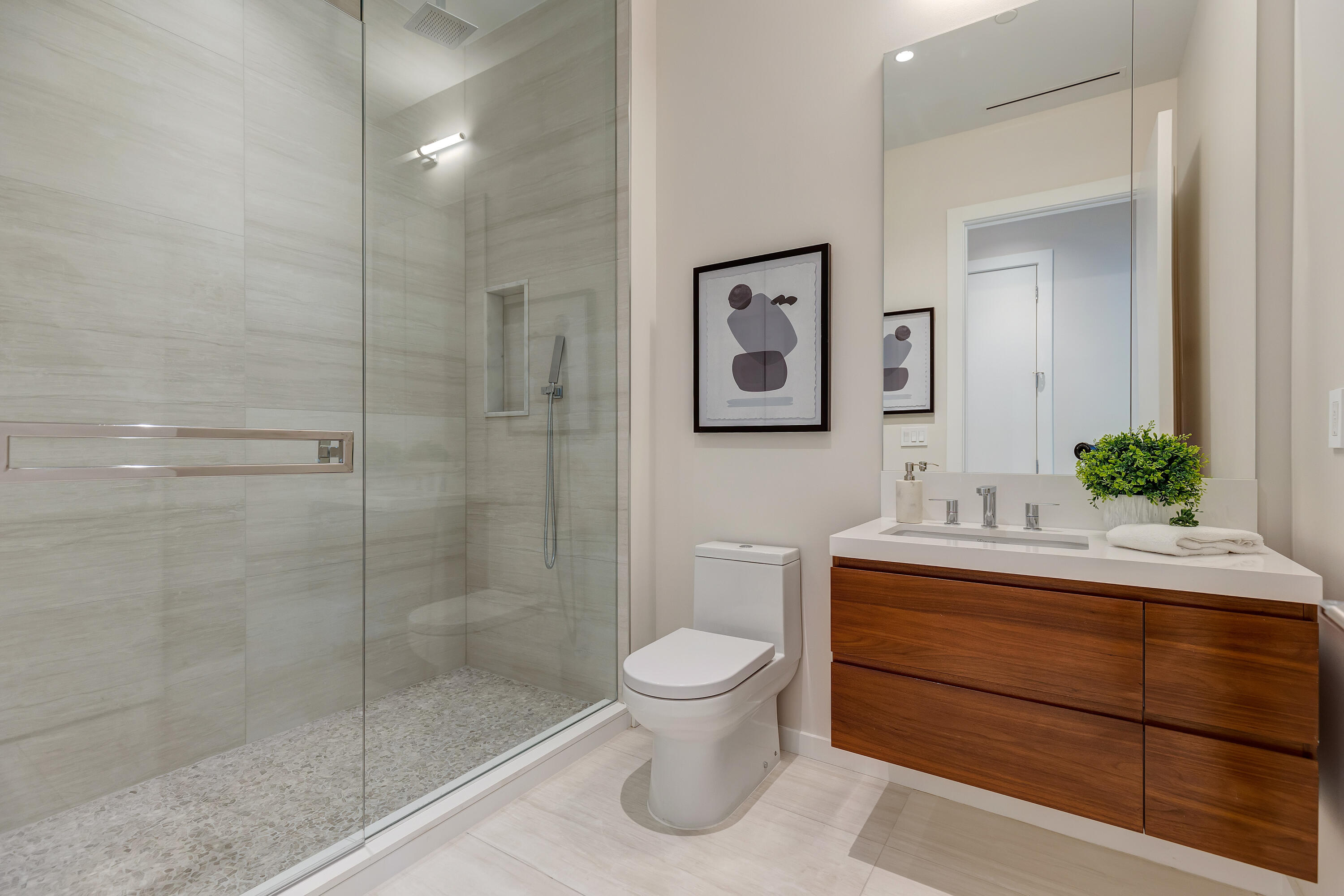 200 Southeast Mizner Boulevard, Unit 106 Boca Raton, FL 33432 - Photo 16 of 43 a bathroom with a sink a toilet and shower