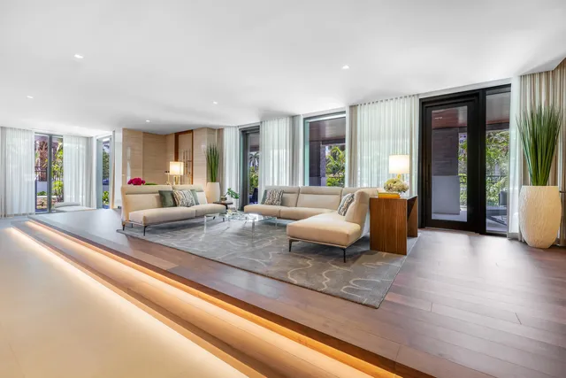 a view of a swimming pool with a patio and plants