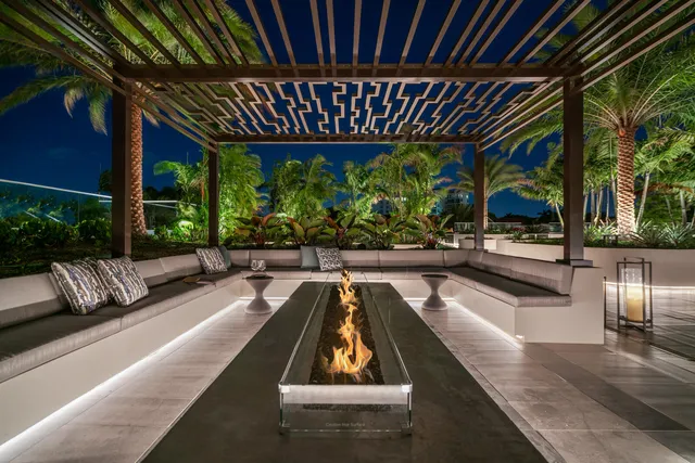a view of a patio with couches table and chairs with potted plants