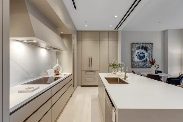 a large white kitchen with a large window