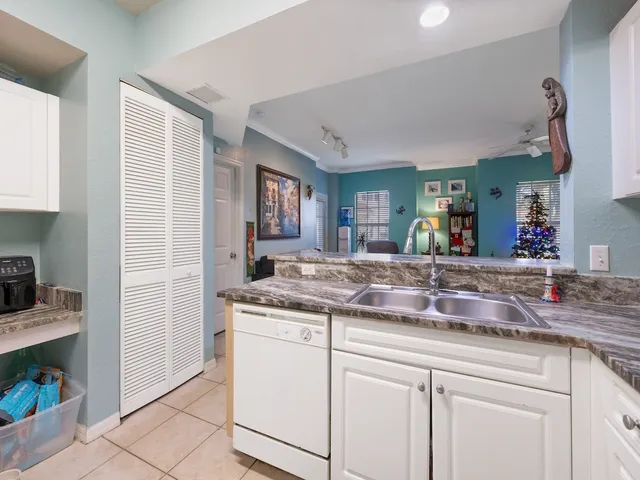 a kitchen with granite countertop a sink and cabinets