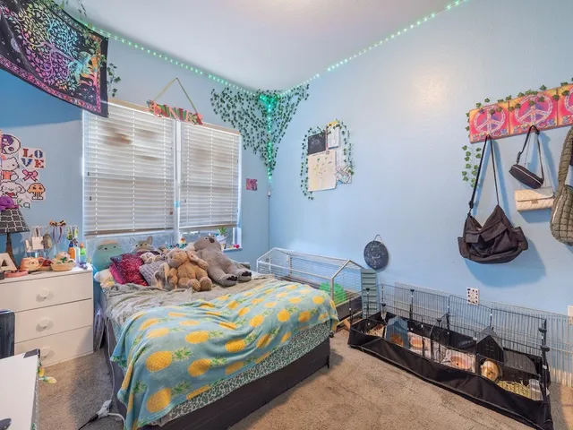 a bedroom with bed and a window