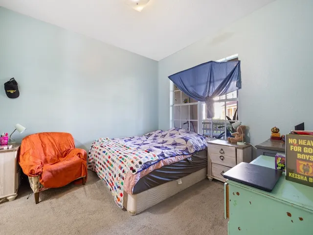 a bedroom with a bed and a couch