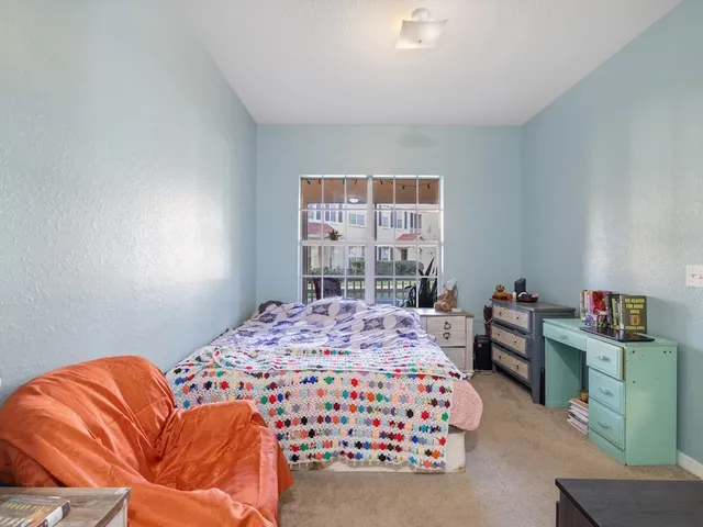 a bedroom with a bed and a window