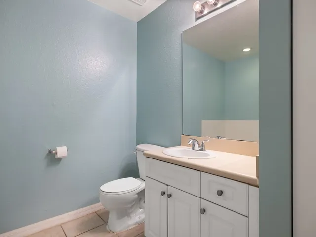 a bathroom with a sink toilet and mirror