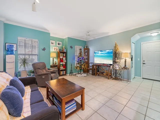 a living room with furniture a window and a flat screen tv