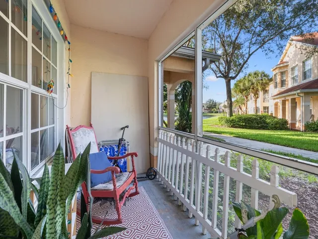 a view of a chair and tables in the porch