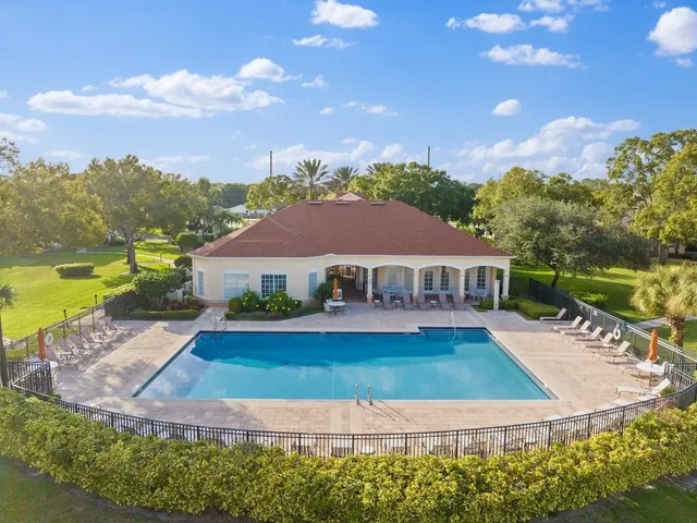 a view of house with garden space swimming pool and outdoor seating