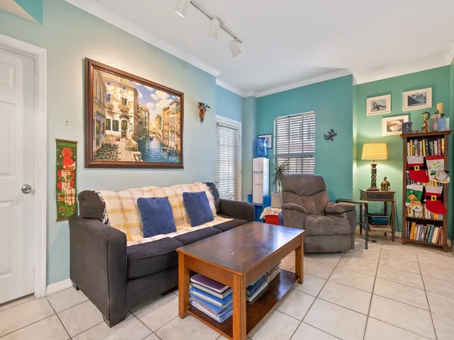 a living room with furniture and a bookshelf