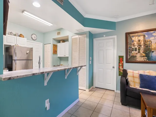 a kitchen with stainless steel appliances granite countertop a refrigerator and a stove