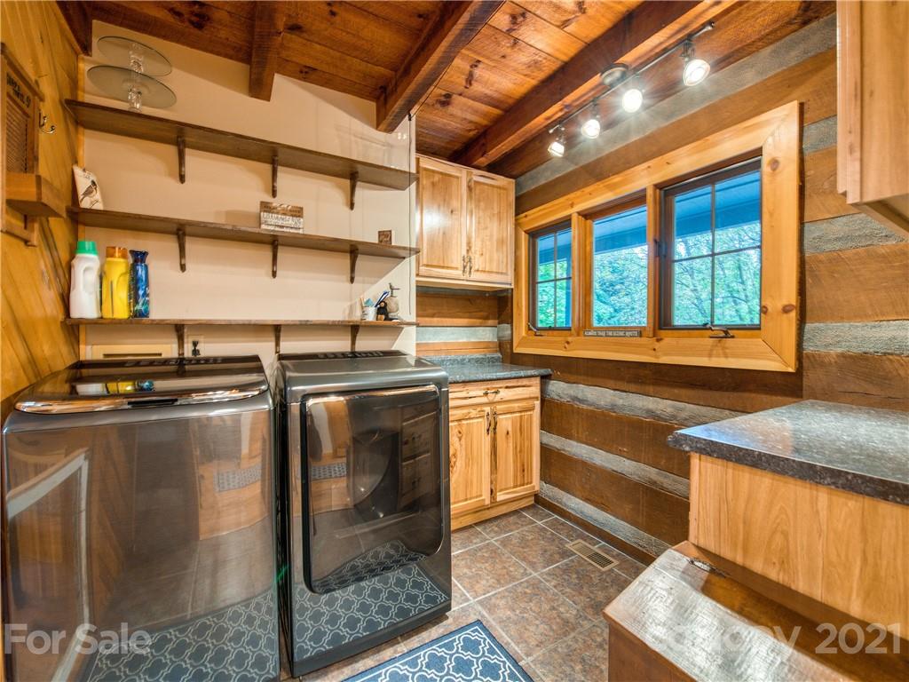 1052 Springbrook Farm Road Waynesville, NC 28786 - Photo 14 of 37 a kitchen with stainless steel appliances granite countertop a stove a sink and a microwave