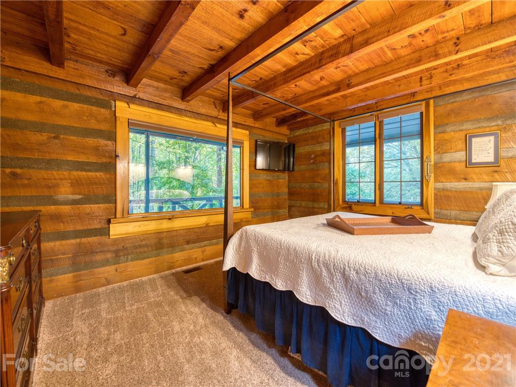 1052 Springbrook Farm Road Waynesville, NC 28786 - Photo 17 of 37 a bedroom with a bed and a large window