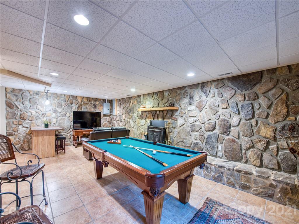 1052 Springbrook Farm Road Waynesville, NC 28786 - Photo 21 of 37 a living room with pool table and a flat screen tv