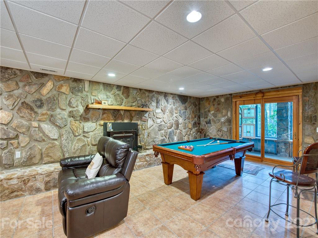 1052 Springbrook Farm Road Waynesville, NC 28786 - Photo 22 of 37 a room with furniture pool table gym equipment and windows
