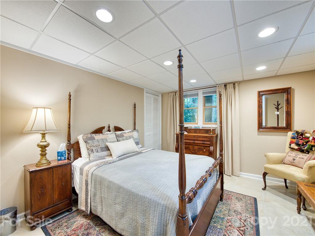 1052 Springbrook Farm Road Waynesville, NC 28786 - Photo 29 of 37 a bedroom with a bed and wooden floor