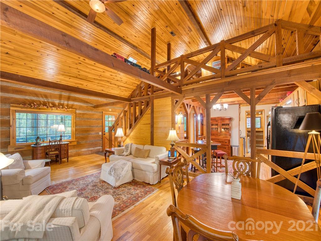 1052 Springbrook Farm Road Waynesville, NC 28786 - Photo 6 of 37 a living room with lots of furniture and chandelier