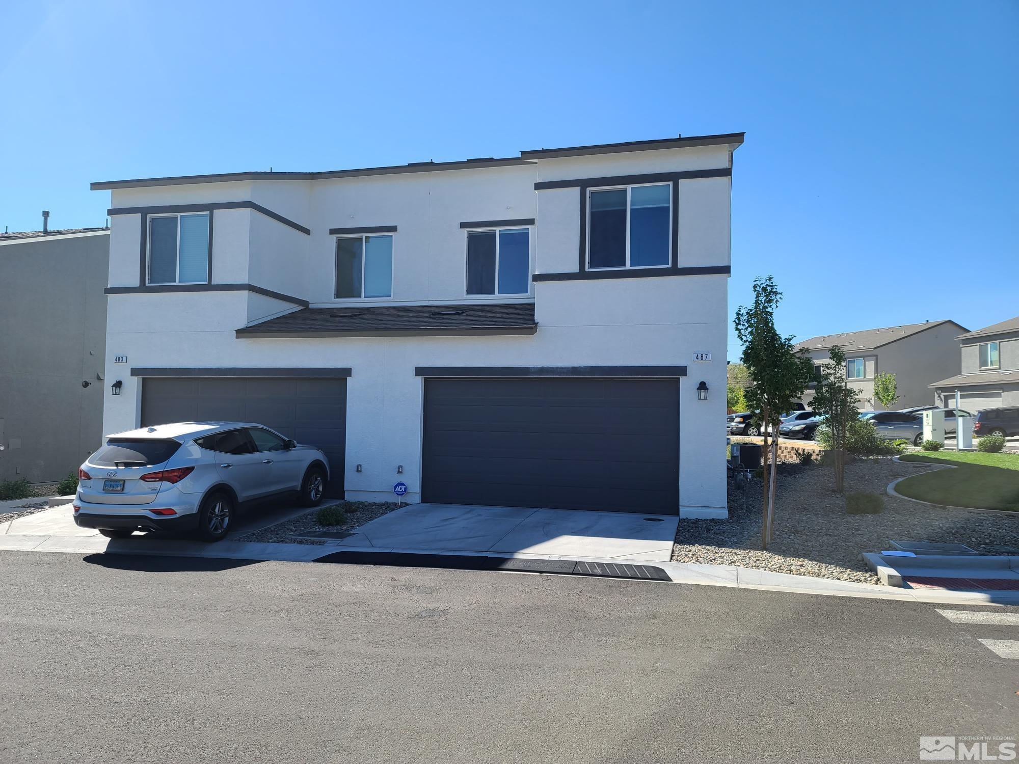 a front view of a house with a road