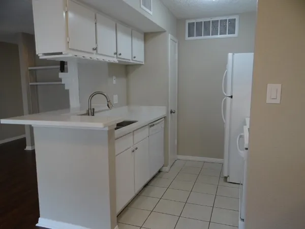 a kitchen with a sink and cabinets
