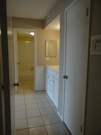 a bathroom with a shower and a sink